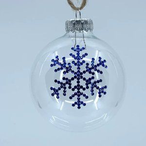 Round plastic Christmas ornament. Handmade blue rhinestone snowflake design.
